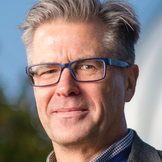 Photo of Paul Budra, SFU Professor, a man with greying hair and glasses