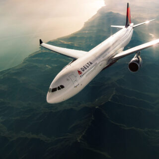 An Airbus 330-300 (333) flying along a coastline.
