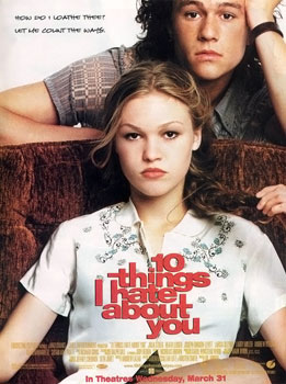 The theatrical release poster for "10 Things I Hate About You" is a close-up of Julia Stiles sitting in a brown armchair. She is wearing a white, short-sleeved, button-down, top with blue flower details around the shoulders. She stares sternly into the camera, holding the end of her braided hair in her left hand above her shoulder. Heath Ledger leans against the back of the chair with his left hand supporting his head. He is wearing a grey, plaid, short-sleeved, button-down, with a neutral expression. The title of the movie is in a clump of red block letters placed in front of Stiles chest.