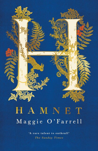 The cover of Maggie O'Farrell's book "Hamnet", is deep blue with a large white "H" taking up the two top thirds of the cover. The "H" is outlined in gold and is surrounded with gold illustrations of ferns, ivy, oak leaves, a squirrel, an owl, and red berries. Below the "H" the title "Hamnet" is displayed in all capitals, serif font, and gold. Below "Hamnet" it reads "Maggie O'Ferrell" in white serif font. Below that, in smaller font, a quote from The Sunday Times reads "a rare talent to enthrall".