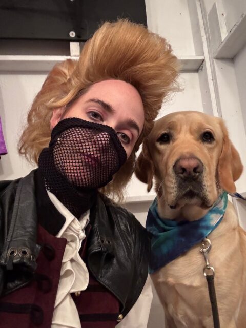 Kristi Hansen as an Outlaw with Taj, a Labrador Retriever, wearing a blue tie-dye bandana.