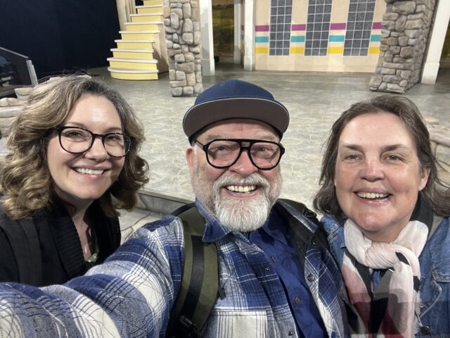 A selfie of Alison Matthews, Dean Paul Gibson, and Nicky Anderton, with the set of The Two Gentlemen of Verona in the background.