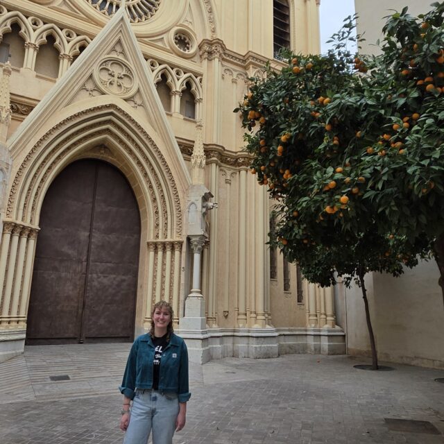 Taylor standing in front of a church in Spain.
